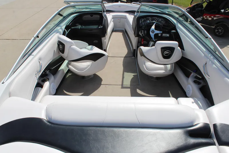 Slide: The Image of Interior view of a 2012 Crownline 21 SS boat with white seating and dashboard. - 8