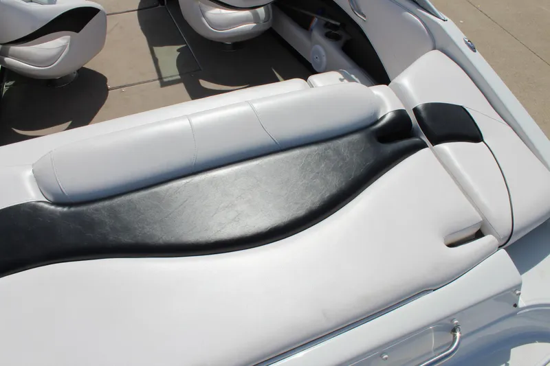 Slide: The Image of Interior seating of a 2012 Crownline 21 SS boat, featuring sleek black and white upholstery. - 9