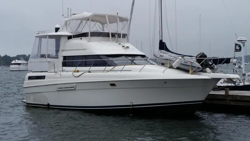 Slide: The Image of 1993 Silverton 41 Aft Cabin yacht docked in a marina, overcast sky. - 10
