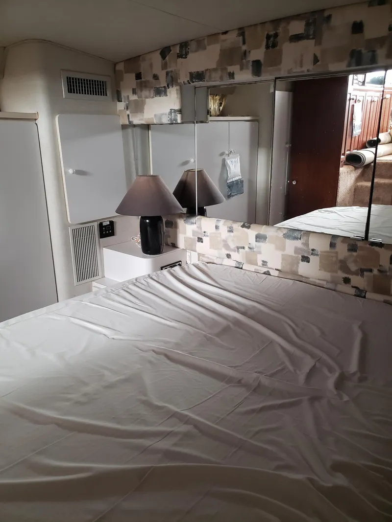 Slide: The Image of Interior of 1993 Silverton 41 Aft Cabin with bed, mirror, and lamp. - 3