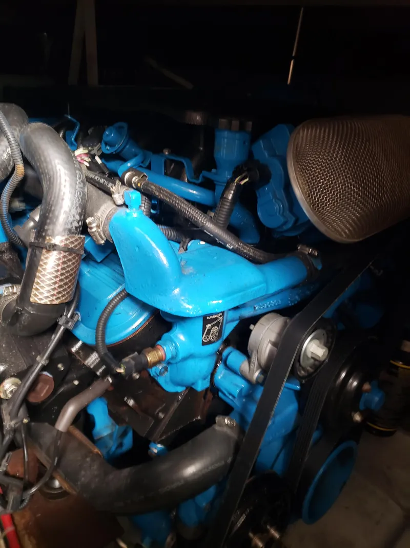 Slide: The Image of Close-up of a 1993 Silverton 41 Aft Cabin engine, showcasing blue components and hoses. - 4