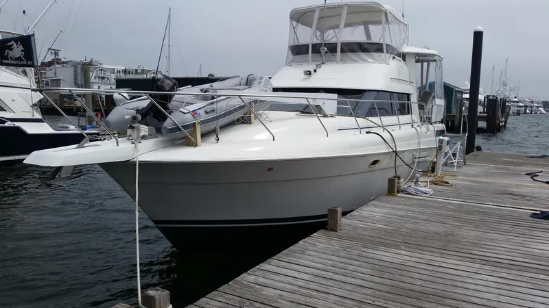 Slide: The Image of 1993 Silverton 41 Aft Cabin yacht docked at a marina. - 6