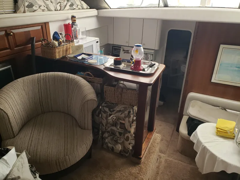 Slide: The Image of Interior of 1993 Silverton 41 Aft Cabin with cozy seating and nautical decor. - 7