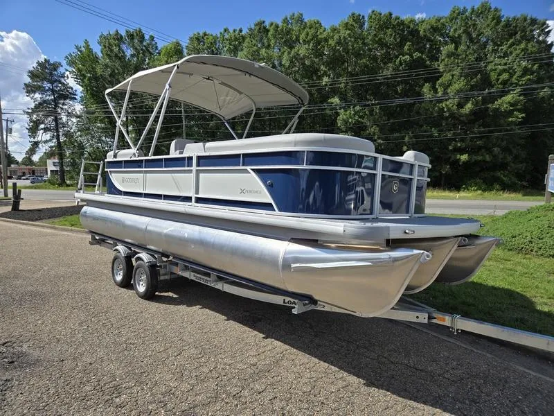 The Image of 2025 Godfrey Xperience 2286 SBX Sport Tube pontoon boat on trailer, parked outdoors. - 1