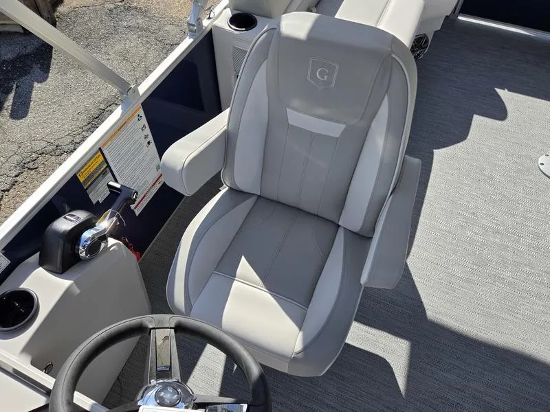 Slide: The Image of Captain's chair on 2025 Godfrey Xperience 2286 SBX Sport Tube boat, featuring sleek design and controls. - 11