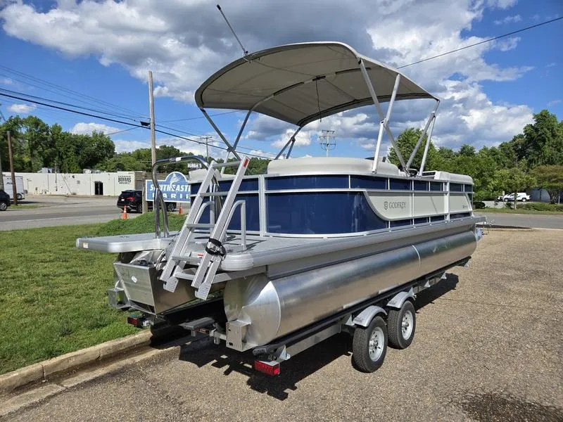 Slide: The Image of 2025 Godfrey Xperience 2286 SBX Sport Tube pontoon boat on trailer, parked outdoors. - 3
