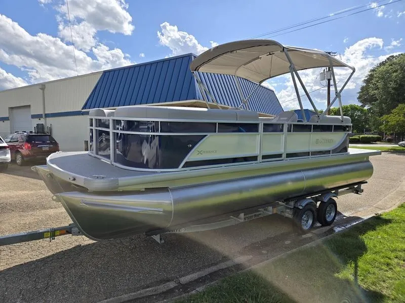 Slide: The Image of 2025 Godfrey Xperience 2286 SBX Sport Tube pontoon boat on trailer, sunny day. - 5