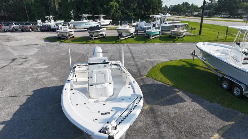 Slide: The Image of 2021 Sea Pro 228 boat displayed in a marina with multiple boats in the background. - 3