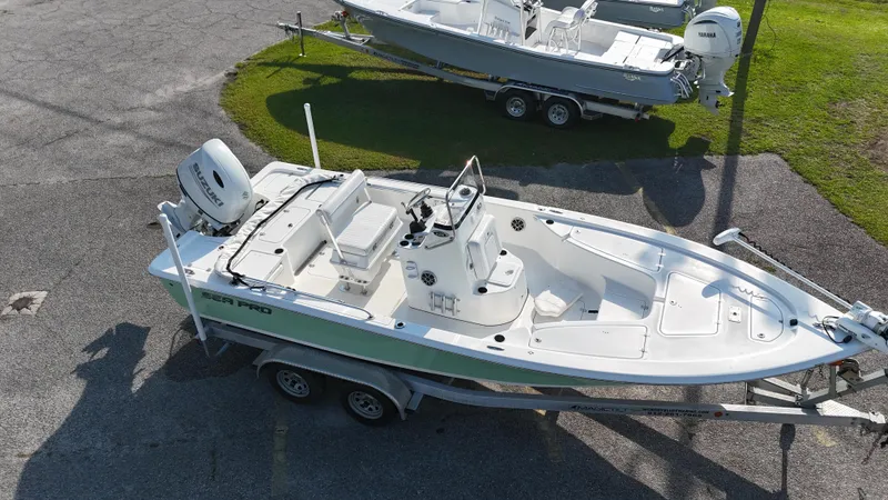 Slide: The Image of 2021 Sea Pro 228 boat on trailer, parked outdoors, aerial view. - 5
