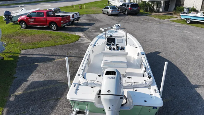 Slide: The Image of 2021 Sea Pro 228 boat parked in a lot, surrounded by vehicles. - 7