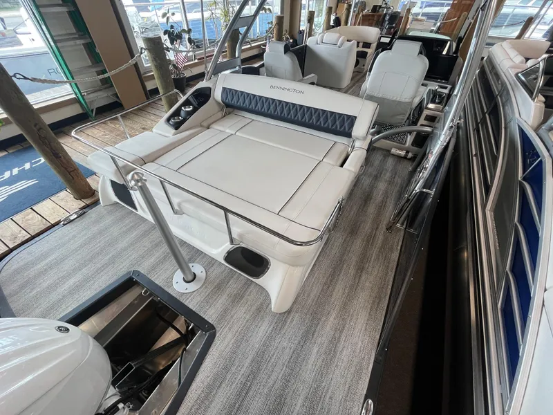 Slide: The Image of 2025 Bennington 25QXSBA luxury boat interior with plush seating and modern design. - 15