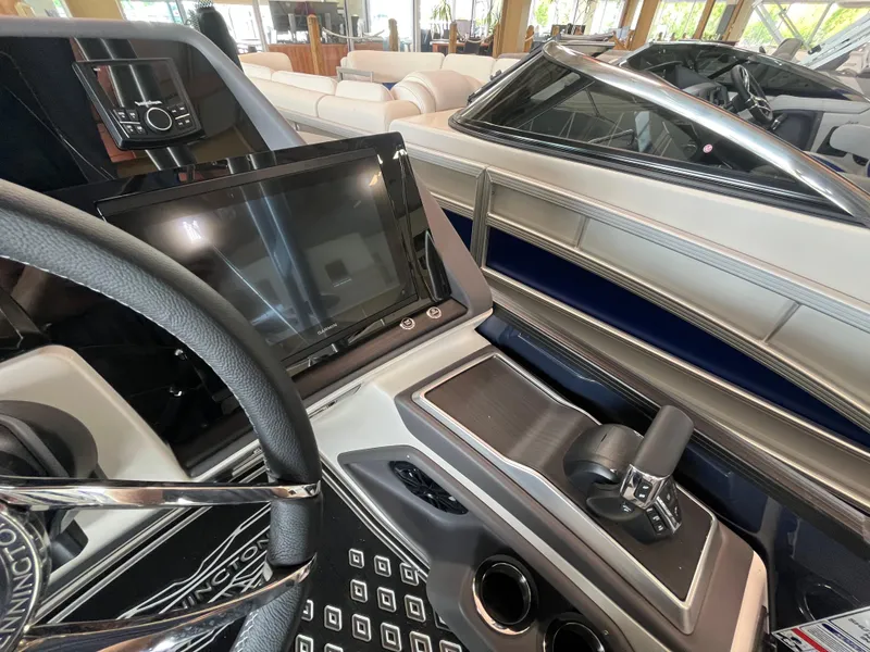 Slide: The Image of 2025 Bennington 25QXSBA boat dashboard with steering wheel and control panel. - 17