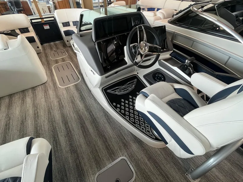 Slide: The Image of 2025 Bennington 25QXSBA boat interior with modern helm, luxurious seating, and sleek design. - 18