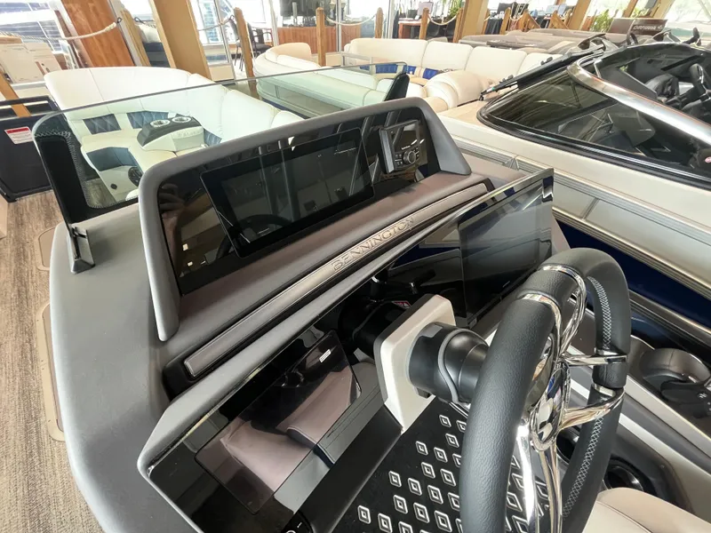 Slide: The Image of 2025 Bennington 25QXSBA boat dashboard with modern steering and control panel. - 20