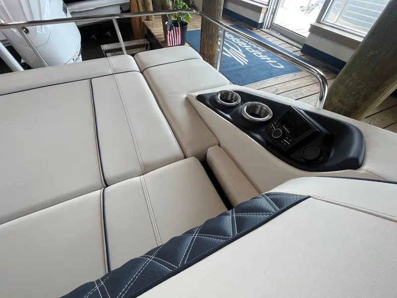 Slide: The Image of 2025 Bennington 25QXSBA boat interior with luxurious seating and cup holders. - 23