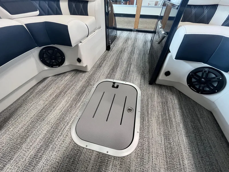 Slide: The Image of 2025 Bennington 25QXSBA boat interior with stylish seating and floor hatch. - 24