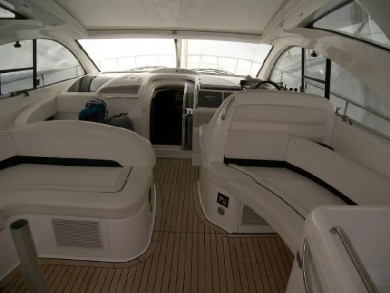 Slide: The Image of Interior of 2007 Fairline Targa 52 yacht with sleek white seating and wooden flooring. - 17