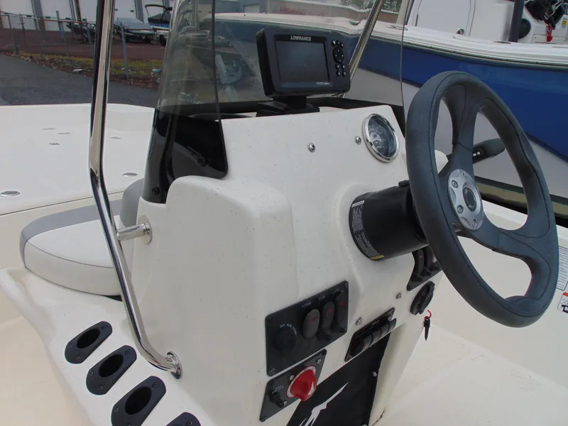 Slide: The Image of 2023 Mako Pro Skiff 17 CC boat console with steering wheel and navigation system. - 10