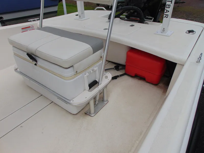 Slide: The Image of 2023 Mako Pro Skiff 17 CC interior with seating and storage compartments. - 11