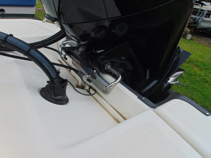 Slide: The Image of 2023 Mako Pro Skiff 17 CC boat engine and steering mechanism close-up. - 14