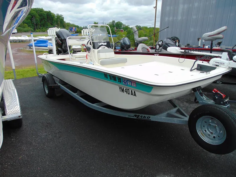 Slide: The Image of 2023 Mako Pro Skiff 17 CC boat on trailer, parked outdoors. - 2