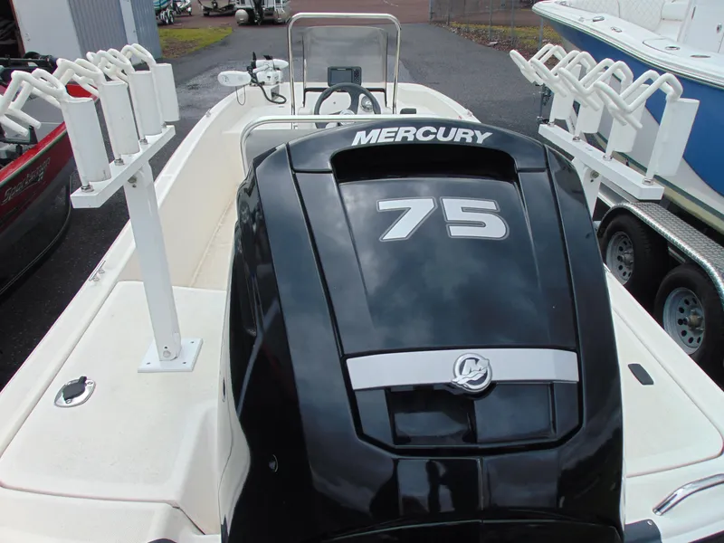 Slide: The Image of 2023 Mako Pro Skiff 17 CC with Mercury 75 engine, featuring rod holders. - 7