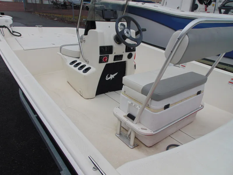 Slide: The Image of 2023 Mako Pro Skiff 17 CC boat interior with steering console and seating. - 9