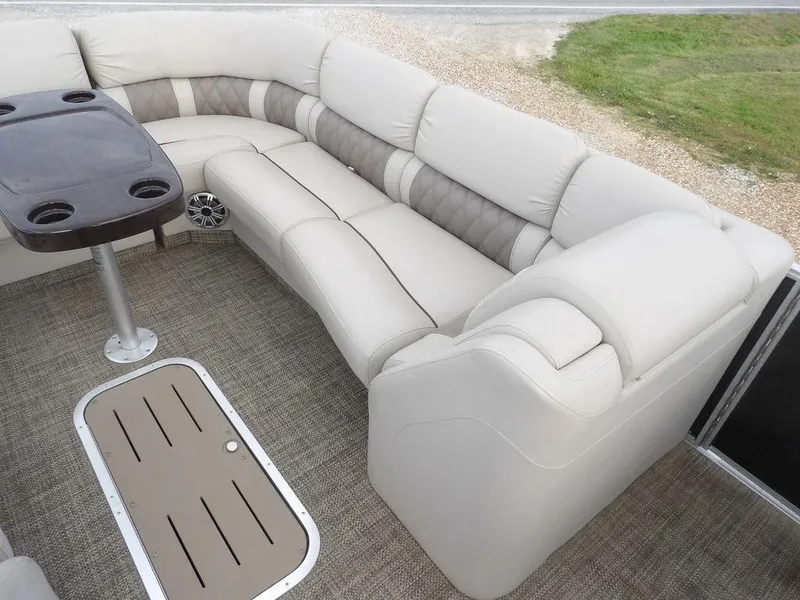 Slide: The Image of 2016 Bennington 2874 QSR boat interior with plush seating and table. - 15