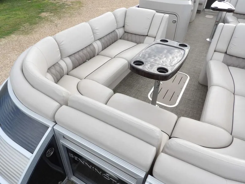 Slide: The Image of 2016 Bennington 2874 QSR pontoon boat with plush seating and a central table. - 16