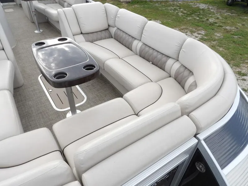 Slide: The Image of 2016 Bennington 2874 QSR pontoon boat with plush seating and table. - 17