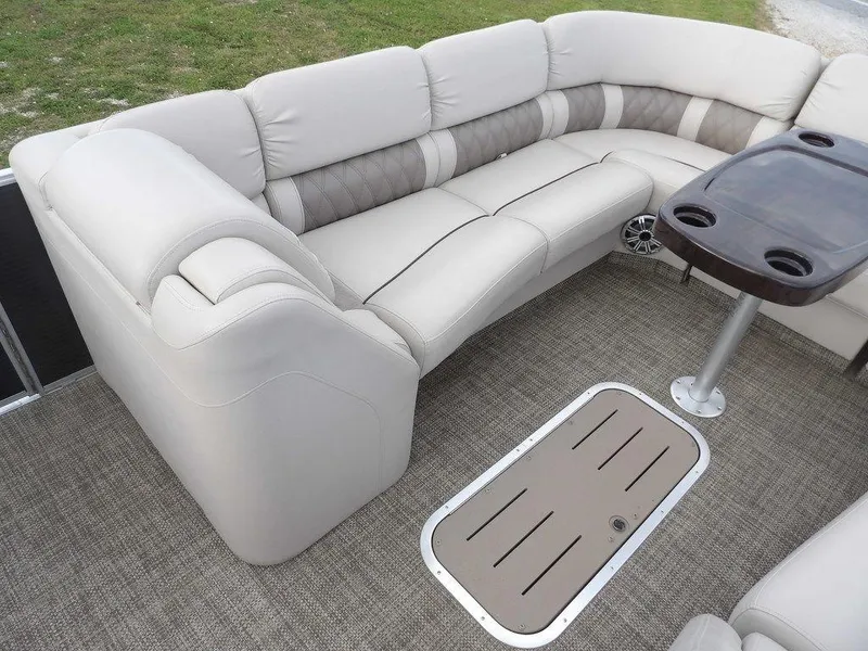 Slide: The Image of Luxurious seating area on a 2016 Bennington 2874 QSR pontoon boat with table and cup holders. - 18