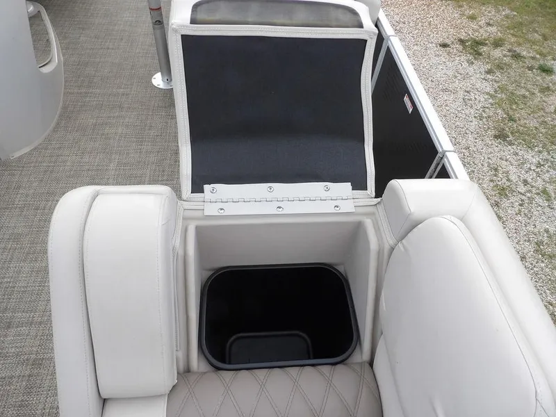 Slide: The Image of 2016 Bennington 2874 QSR boat interior with storage compartment and seating. - 22