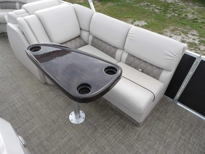 Slide: The Image of Luxurious seating on 2016 Bennington 2874 QSR boat with sleek table and cup holders. - 24