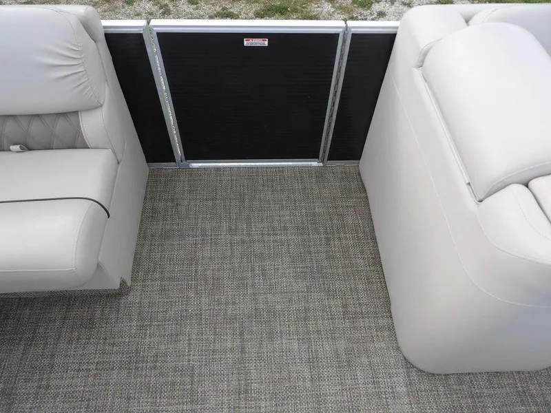Slide: The Image of 2016 Bennington 2874 QSR boat interior with gray seating and carpet flooring. - 26