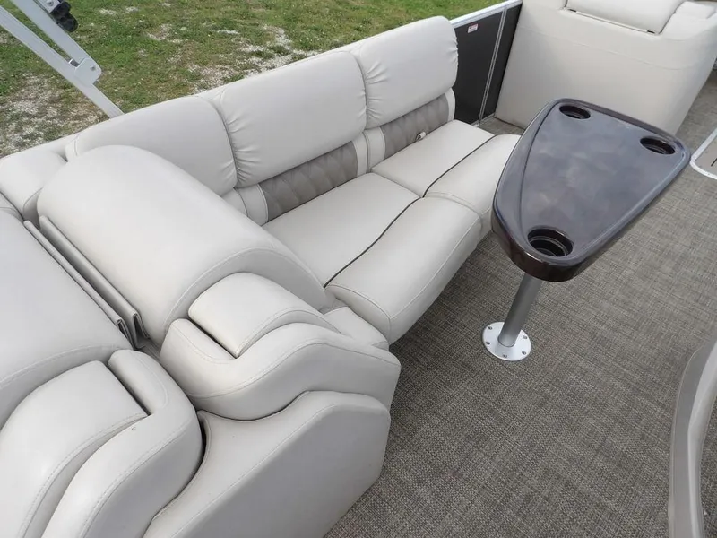 Slide: The Image of Luxurious seating on 2016 Bennington 2874 QSR pontoon boat with table and cup holders. - 27