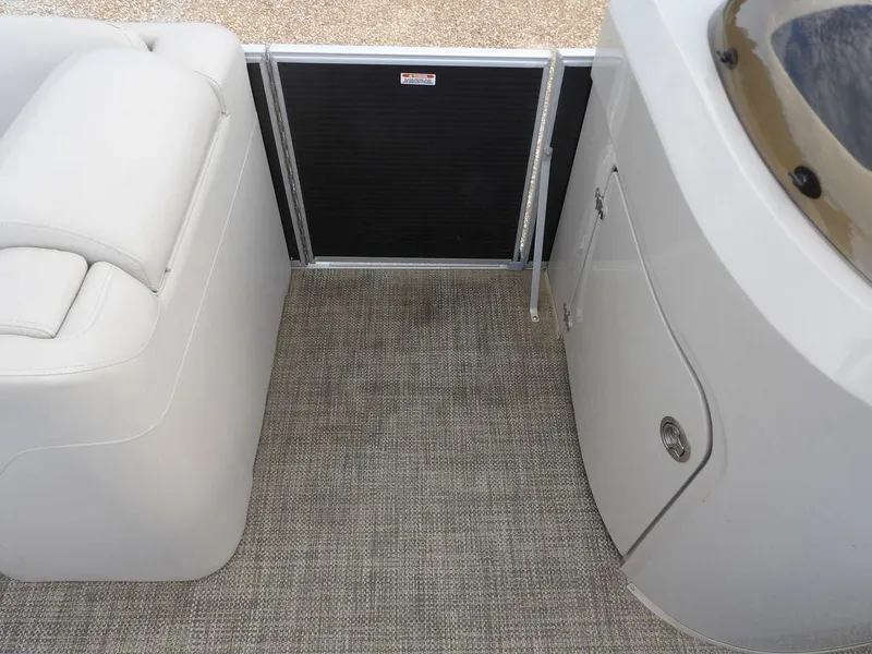 Slide: The Image of 2016 Bennington 2874 QSR boat interior with seating and storage compartment. - 28