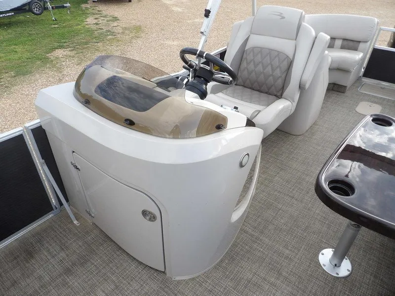 Slide: The Image of 2016 Bennington 2874 QSR boat interior with steering console and seating. - 29