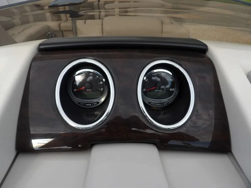 Slide: The Image of Dashboard of 2016 Bennington 2874 QSR boat with dual gauges and wood finish. - 37