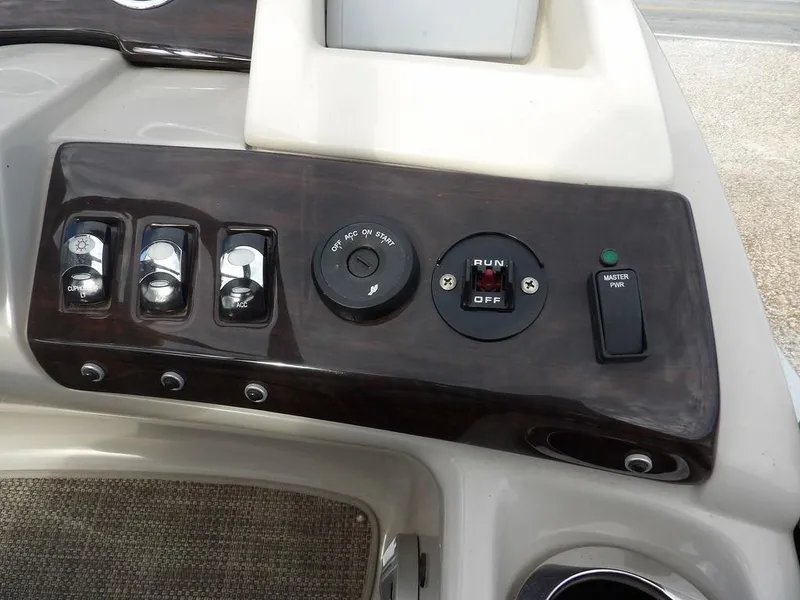 Slide: The Image of Control panel of a 2016 Bennington 2874 QSR boat with switches and ignition. - 38