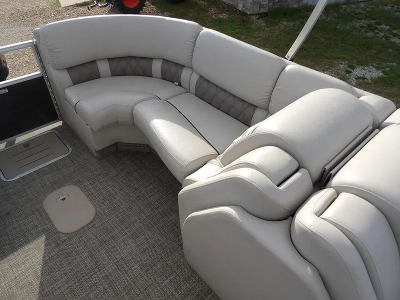 Slide: The Image of Luxurious seating on a 2016 Bennington 2874 QSR pontoon boat, featuring plush, curved upholstery. - 41