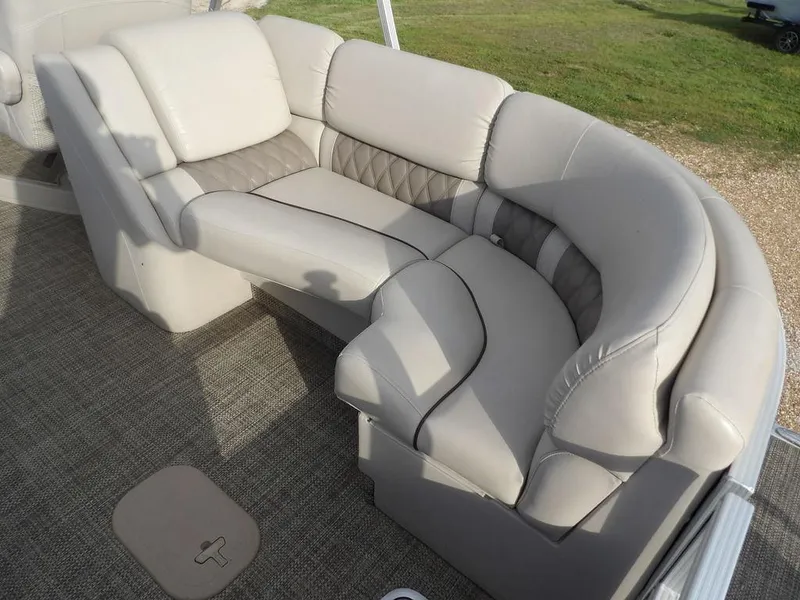 Slide: The Image of 2016 Bennington 2874 QSR boat seating with beige upholstery and diamond-patterned accents. - 42
