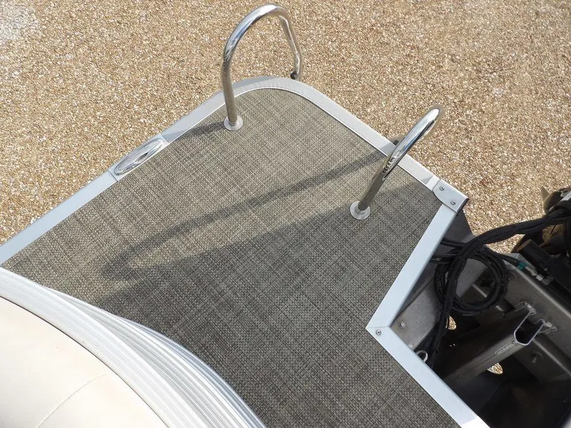 Slide: The Image of 2016 Bennington 2874 QSR boat deck with ladder and textured flooring. - 45