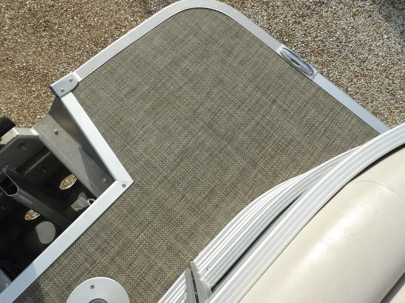 Slide: The Image of 2016 Bennington 2874 QSR boat deck with textured flooring and metal trim. - 46