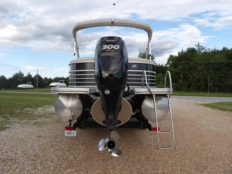 Slide: The Image of 2016 Bennington 2874 QSR pontoon boat with powerful 300 HP engine, parked on gravel. - 8
