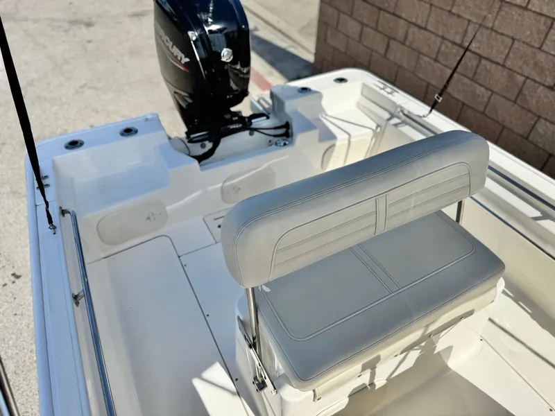 Slide: The Image of 2021 Boston Whaler 170 Montauk boat interior with seating and motor. - 13