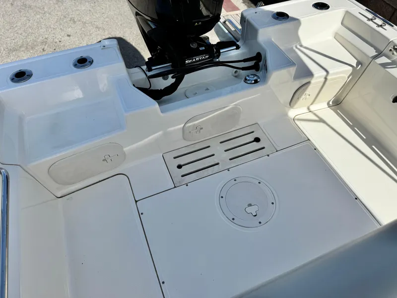 Slide: The Image of 2021 Boston Whaler 170 Montauk boat interior with motor and seating area. - 14