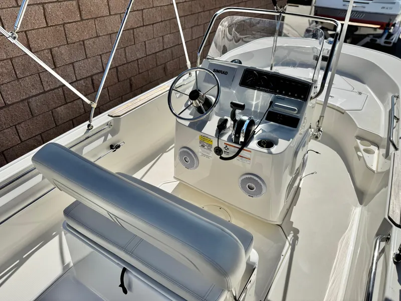 Slide: The Image of 2021 Boston Whaler 170 Montauk boat interior with steering console and seating. - 16