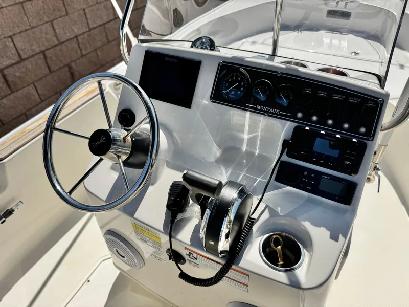 Slide: The Image of 2021 Boston Whaler 170 Montauk boat console with steering wheel and controls. - 18