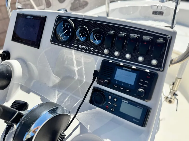 Slide: The Image of Dashboard of 2021 Boston Whaler 170 Montauk with navigation and control instruments. - 19