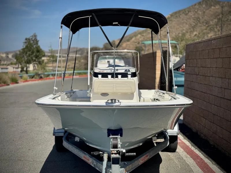 Slide: The Image of 2021 Boston Whaler 170 Montauk boat on trailer, parked outdoors. - 2